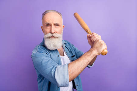 Photo of cute bully age gentleman wear jeans shirt arm waist beating bit isolated violet color backgroundの写真素材