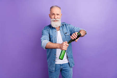 Photo of aged man happy positive smile open beer party drink weekend isolated over purple color backgroundの写真素材