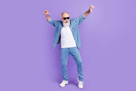 Full body photo of aged man happy positive smile have fun dance party isolated over violet color...