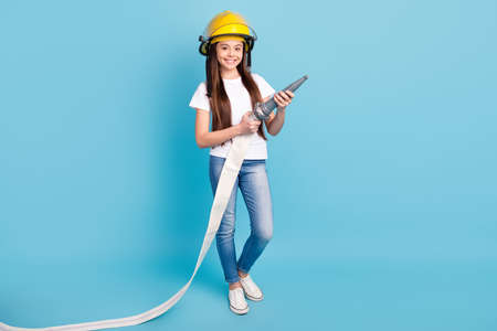 Full length body size view of attractive trendy cheerful girl fighting fire with water isolated over...