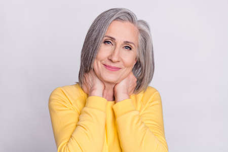 Photo of happy good mood pretty charming smiling mature woman wear yellow sweater isolated on grey...