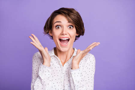 Portrait of attractive amazed cheerful girl executive manager having fun great news isolated over...