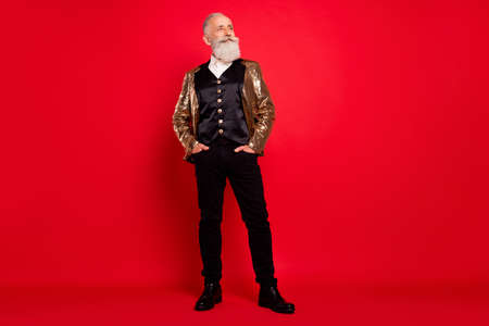 Full length body size view of attractive cheerful grey-haired man posing hands in pockets copy space...
