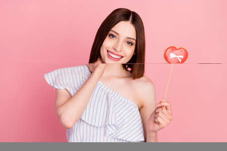 Photo of young girl happy positive smile hold cookies heart figure romantic isolated over pink color...
