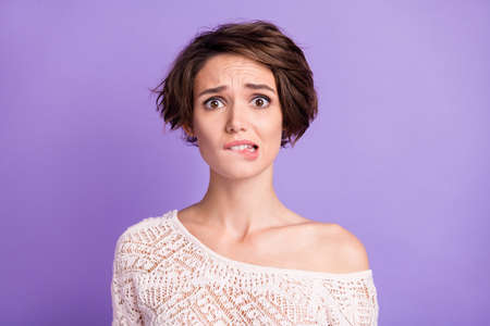 Portrait of nice hairstyle worried young girl biting lips look camera isolated on pastel purple...