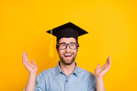 Photo of young man happy positive smile amazed excited look empty space mortarboard isolated over...