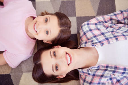 Top above high angle view photo of happy positive sisters smile good mood indoors inside house home
