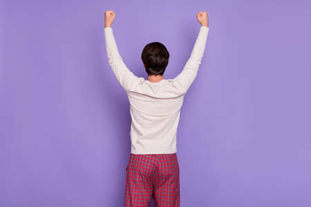 Rear photo of unknown young person raise hands fists up isolated on pastel purple color background