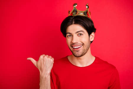 Photo of positive rich king guy indicate thumb finger empty space wear red t-shirt isolated red color backgroundの写真素材