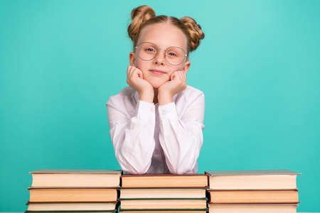 Photo of think small girl with books wear white shirt spectacles isolated on teal background