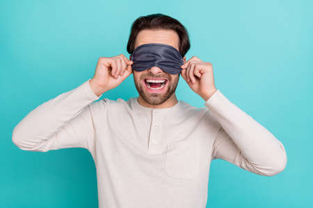 Photo of young man excited close eyes sleeping mask bedtime isolated over turquoise color background
