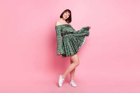 Full length body size view of attractive cheerful girl posing enjoying event occasion isolated over pink pastel color backgroundの写真素材