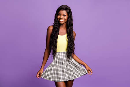 Photo of optimistic curly girl wear green top skirt isolated on vibrant purple color background