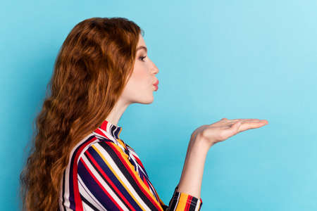 Profile photo of lovely orange hairdo millennial lady blow kiss wear colorful shirt isolated on blue...