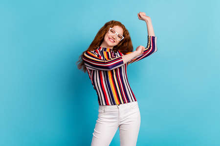 Photo of funny orange hairdo lady dance wear spectacles colorful shirt isolated on blue color...
