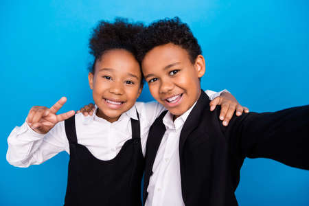 Photo of dark skin little small children people friends make selfie wear formalwear uniform v-signの写真素材