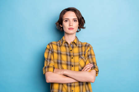 Photo of charming self-assured lady crossed hands look camera wear checkered shirt isolated blue color backgroundの写真素材