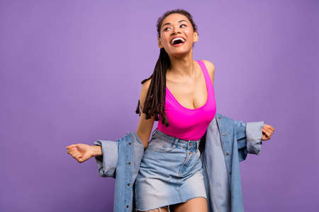 Portrait of attractive overjoyed cheerful girl dancing having fun isolated over bright purple violet...
