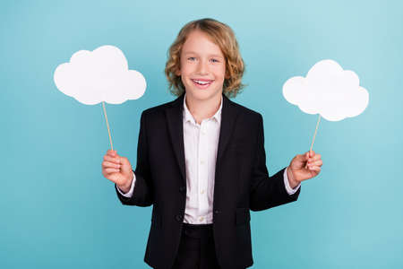 Photo of nice little blond boy hold clouds wear uniform isolated on blue color background