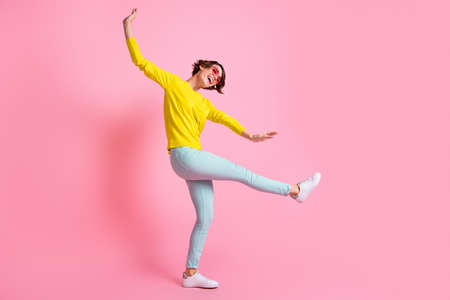 Full size photo of young attractive happy excited cheerful positive girl dancing enjoy weekend isolated on pink color backgroundの写真素材