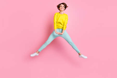 Full size photo of young attractive cheerful positive careless funky girl jumping isolated on pink...