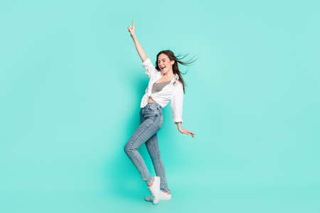 Full body photo of attractive nice positive young woman point finger disco dance isolated on teal color backgroundの写真素材