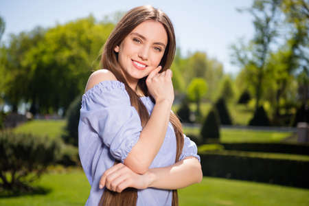 Portrait of attractive cheerful girl posing enjoying spending free spare time vacation at downtown outdoorsの写真素材