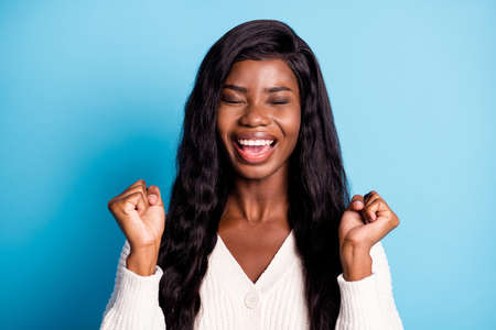 Photo portrait cheerful happy black skinned girl gesturing like lottery winner isolated vibrant blue color backgroundの写真素材