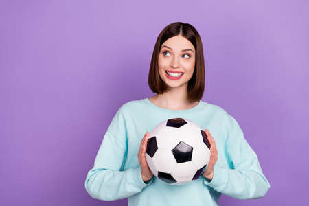 Photo portrait girl keeping soccer ball game fan looking copyspace isolated pastel purple color...