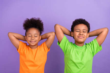 Top above high angle photo of two young black kids rest relax sleep hands behind head isolated over...