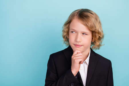 Photo of minded clever schoolboy finger chin look empty space wear uniform isolated blue color...