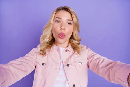 Photo of carefree excited person take selfie tongue out have good mood isolated on purple color...