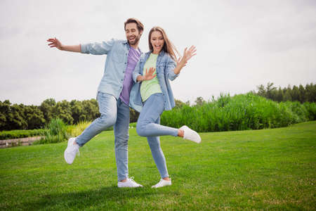 Full size photo of smiling good mood dancing couple enjoying free time active energetic weekend...