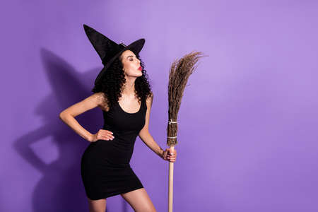 Photo of young beautiful attractive woman witch pout lips kiss hold broomstick celebrate halloween...