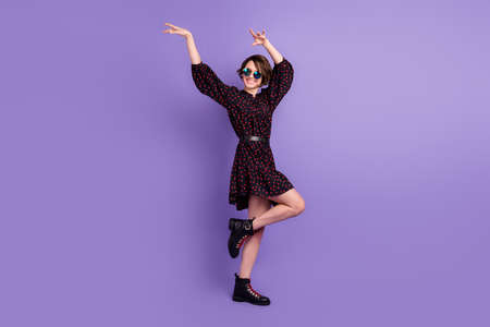 Full length body size view of attractive cheerful girl dancing. isolated over bright violet purple...