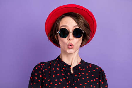 Close-up portrait of girl pout lips isolated over bright violet purple color backgroundの写真素材