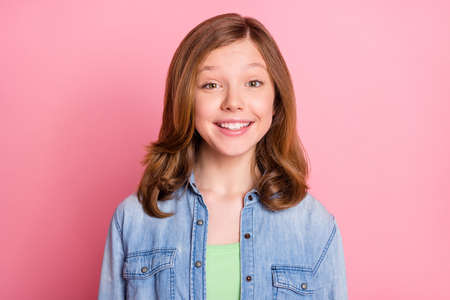 Photo of girl wearing jeans outfit isolated pastel pink color backgroundの写真素材