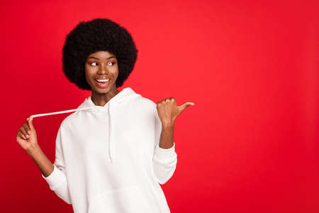 Photo of impressed brunette millennial lady point look empty space wear white sportswear isolated on...