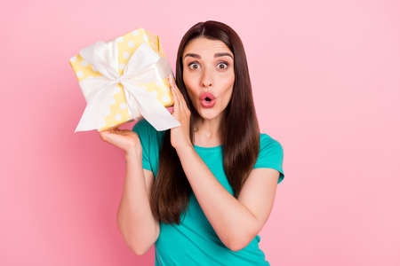 Photo of young woman amazed surprised receive gift holiday unexpected isolated over pastel color...