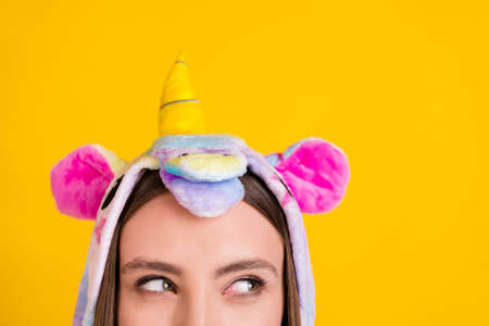 Cropped photo portrait female teenager funny pajama cunning looking blank space isolated vibrant yellow backgroundの写真素材
