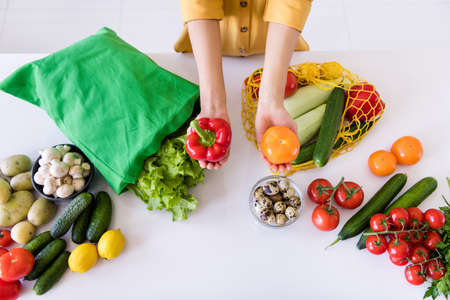 Photo of pretty sweet dark skin woman dressed yellow shirt holding fresh vegetables smiling indoors...