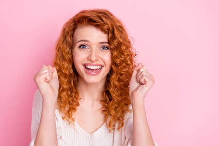 Photo portrait of curly girl smiling surprised gesturing like winner isolated pastel pink color...