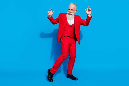 Full body photo of aged rich man happy positive smile have fun dance party isolated over blue color backgroundの写真素材