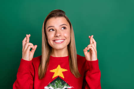 Portrait of attractive cheery hopeful blonde girl holding crossed fingers waiting present isolated...