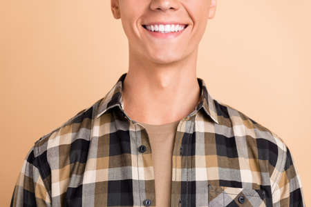 Cropped photo of millennial nice guy wear checkered shirt isolated on beige color backgroundの写真素材