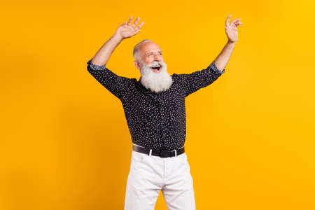 Photo of old cool funny funky man look empty space dance enjoy isolated on shine yellow color backgroundの写真素材