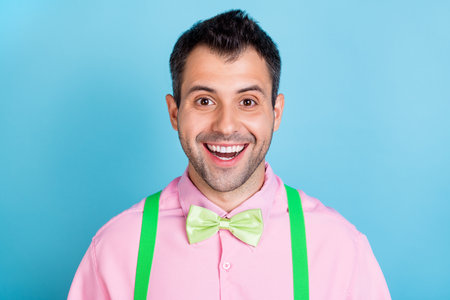 Photo of cool brunet hairdo funny man wear pink shirt isolated on blue color background