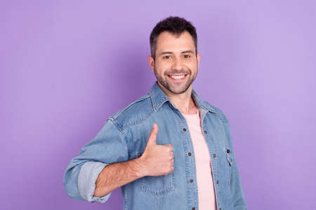 Photo of young man happy positive smile show thumb-up like cool perfect fine advice ad isolated over violet color backgroundの写真素材