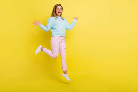 Full length body size view of pretty cheerful girl jumping walking having fun copy space isolated...