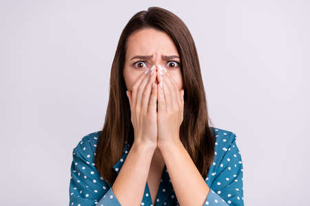 Photo of impressed amazed young lady wear dotted shirt arms close lips face isolated grey color...